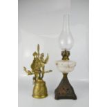 A Victorian oil lamp, together with a cast metal bell with wall bracket.
