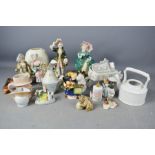 A group of ceramic figurines, teapot and a jug.