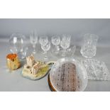 A quantity of glassware including vases, wine glasses and other items.