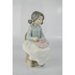 A Nao Lladro figure of young girl sewing, 16cm high.