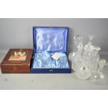 A group of cut glass decanters and a Thomas Webb glasses set.