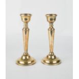 A pair of silver weighted candlesticks.