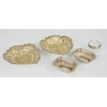 A group of silver dishes, including two salts, pierced and embossed bon bon dishes, 2.41toz.