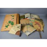 A group of hand painted Chinese fans and postcards.