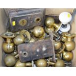 A quantity of brass and ceramic door fittings.