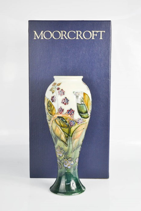 A Moorcroft vase, blackberry pattern, signed by William Moorcroft, in the original box.