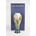 A Moorcroft vase, blackberry pattern, signed by William Moorcroft, in the original box.