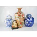 A Chinese blue and white ginger jar, buddha a further blue and white jar and cover and vase.