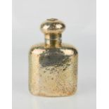 A silver flask with hammered finish.