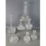 A group of cut glass and crystal decanters, including one small example with a silver collar.