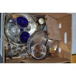 A group of silver plate to include blue glass lined bowls, trays, wine coaster and other items.