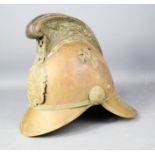 An antique brass fire helmet.