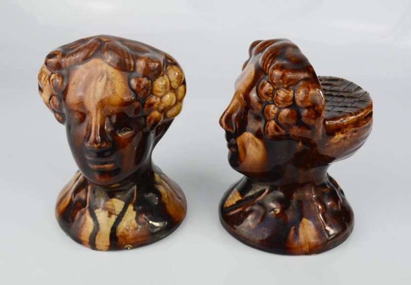A pair of rare late 18th century stoneware treacle glazed furniture rests in the form of female