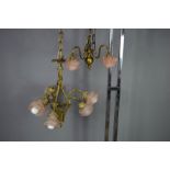 A 1930s chandelier and wall light with pink glass rose form shades.