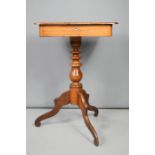 A mahogany work table with single drawer, mother of pearl escutcheon, and tripod base.