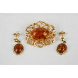 A 9ct gold and amber brooch with matching earrings, 9.3g in total.