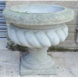 An antique style fibreglass planter.