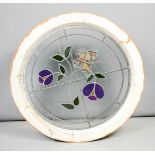 A circular stained glass window, depicting flowers, inner glass 48cm diameter, outer frame 59cm