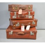 Four vintage suitcases.