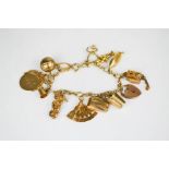 A 9ct gold charm bracelet, including champagne bucket, speed boat, wish bone and many others, 36g