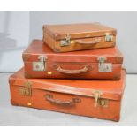 Three vintage suitcases.