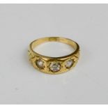 An 18ct gold and diamond ring, set with three old cut diamonds, size N, 5g.