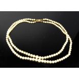 A natural pearl necklace, with 9ct gold clasp of rectangular for, inset with pearl.