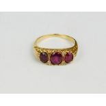 An 18ct gold and ruby ring in a Victorian setting, and three oval cut rubies, 4.7g.