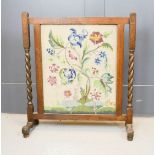 An oak embroidered fire screen, 64 by 72cm.