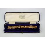A 15ct gold gate bracelet, with safety chain, and original presentation box by Leighton & Son of