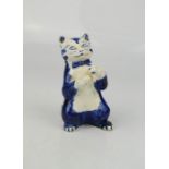A 19th century blue and white model cat wearing a bow tie, blue dot mark.