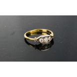 An 18ct gold and diamond ring, the three stones set in platinum, O½, 2.8g