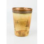 An early 19th century horn beaker, with copper lining and rim, 10cm high.