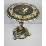 A Victorian black lacquered occasional tilt top table, inlaid with mother of pearl.