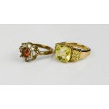 A 9ct gold and cut glass yellow ring size L½ and a silver gilt flowerhead paste ring.