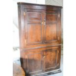 A Country House 18th century oak corner cupboard of large proportions, with shelved interior.