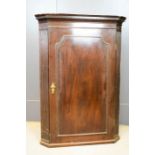 A 19th century mahogany corner cabinet, with key, 74 by 40 by 104cm.