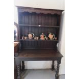 An oak dresser, raised on a base with barleytwist legs.