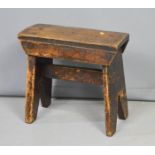 A rustic early 19th century oak stool 35 by 17 by 32cm.