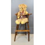 A Victorian high chair, together with a vintage teddy bear.