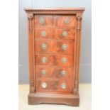 A miniature Wellington type mahogany chest of drawers, with locking side panels enclosing the