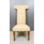 A mahogany framed prie dieux, upholstered in floral tapestry.