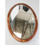 A mahogany oval wall mirror.