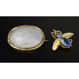 A gilt metal and white agate oval brooch, together with a gold coloured and blue paste bee brooch.