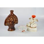A brown glazed Staffordshire spirit flask, tea cup, and 19th century Staffordshire spill vase.