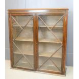 A glazed bookcase with two astrigal glazed doors enclosing shelves.