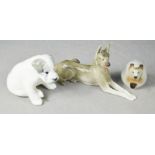 Three Russian ceramic animal figurines; hedgehog, alsatian, and puppy.