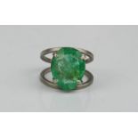 A native cut emerald ring, 13mm by 10mm, approximately 7cts.