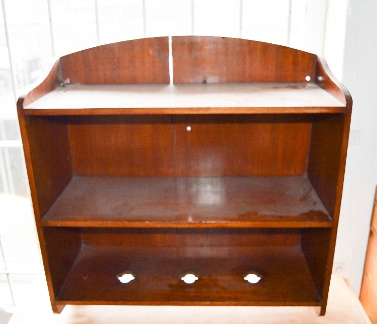 A mahogany wall rack, with shaped back.