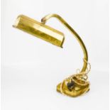 A brass 1950s desk lamp with rotating shade.